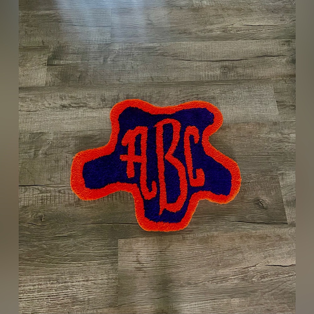 A handmade tufted monogram rug (any letters and colors can be changed)